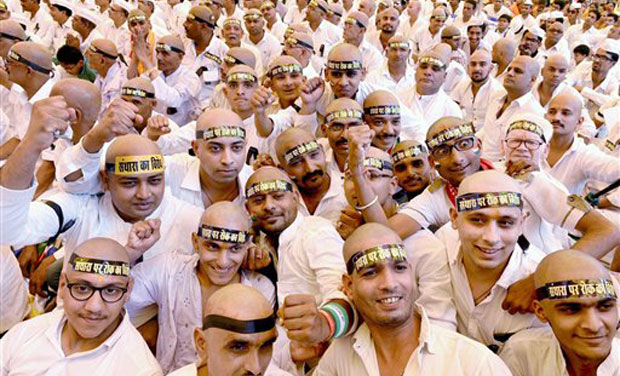 Jain community members shaved their heads in Bhopal on Monday as a mark of protest against the recent Rajasthan High Court order banning the religious practice of 'Santhara'. (Photo: PTI) Jain community members shaved their heads in Bhopal on Monday as a mark of protest against the recent Rajasthan High Court order banning the religious practice of 'Santhara'. (Photo: PTI)